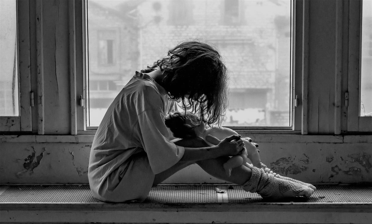 Monochrome Portrait of a Girl Sitting by the Window